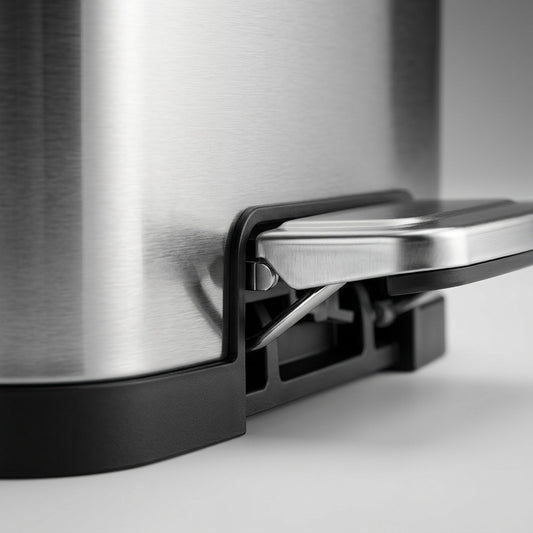 Macro detail of the durable steel foot pedal and smudge-free finish on a Tramontina step can.