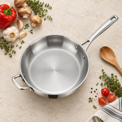 Overhead flat-lay of a Tramontina Signature Tri-Ply 12 inch stainless steel fry pan with vegetables