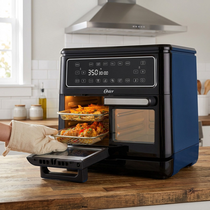 Oster 11-Quart Flex Air Fryer Oven Black on wooden kitchen counter cooking fries and chicken wings