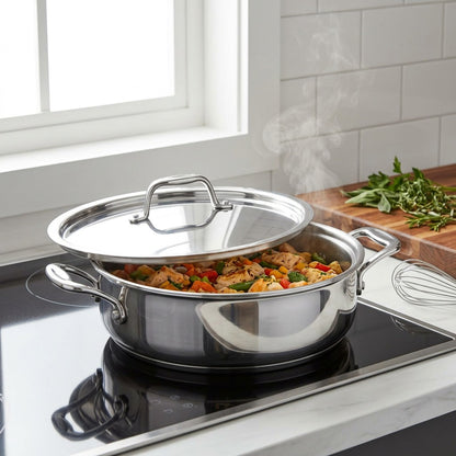 Tramontina Signature 3 Qt Tri-Ply Clad Covered Braiser on an induction stovetop.
