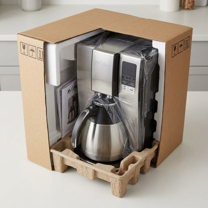 A Mr. Coffee 10-Cup Thermal Coffee Maker securely packed in a shipping box with foam and inserts.