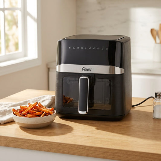 Oster 4-Quart Digital Air Fryer with viewing window on a counter next to a bowl of sweet potato fries.