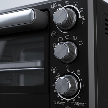 Macro detail of the Oster Compact Air Fryer Oven's silver control knobs and matte black interface.