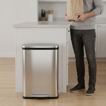 Scale of Tramontina 13 gallon step can shown next to a kitchen island and a person for size.