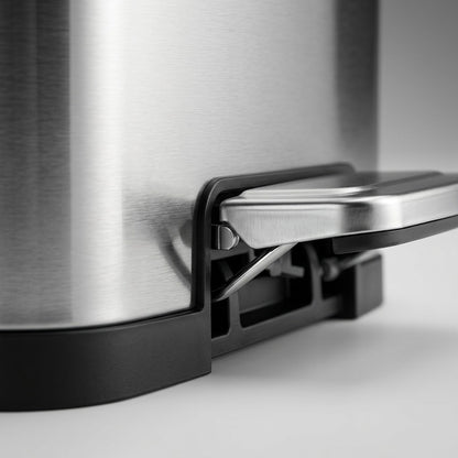 Macro detail of the durable steel foot pedal and smudge-free finish on a Tramontina step can.