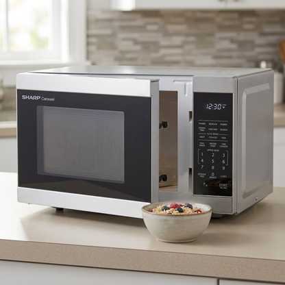 Sharp SMC1162KSC microwave on beige countertop with bowl of oatmeal lifestyle
