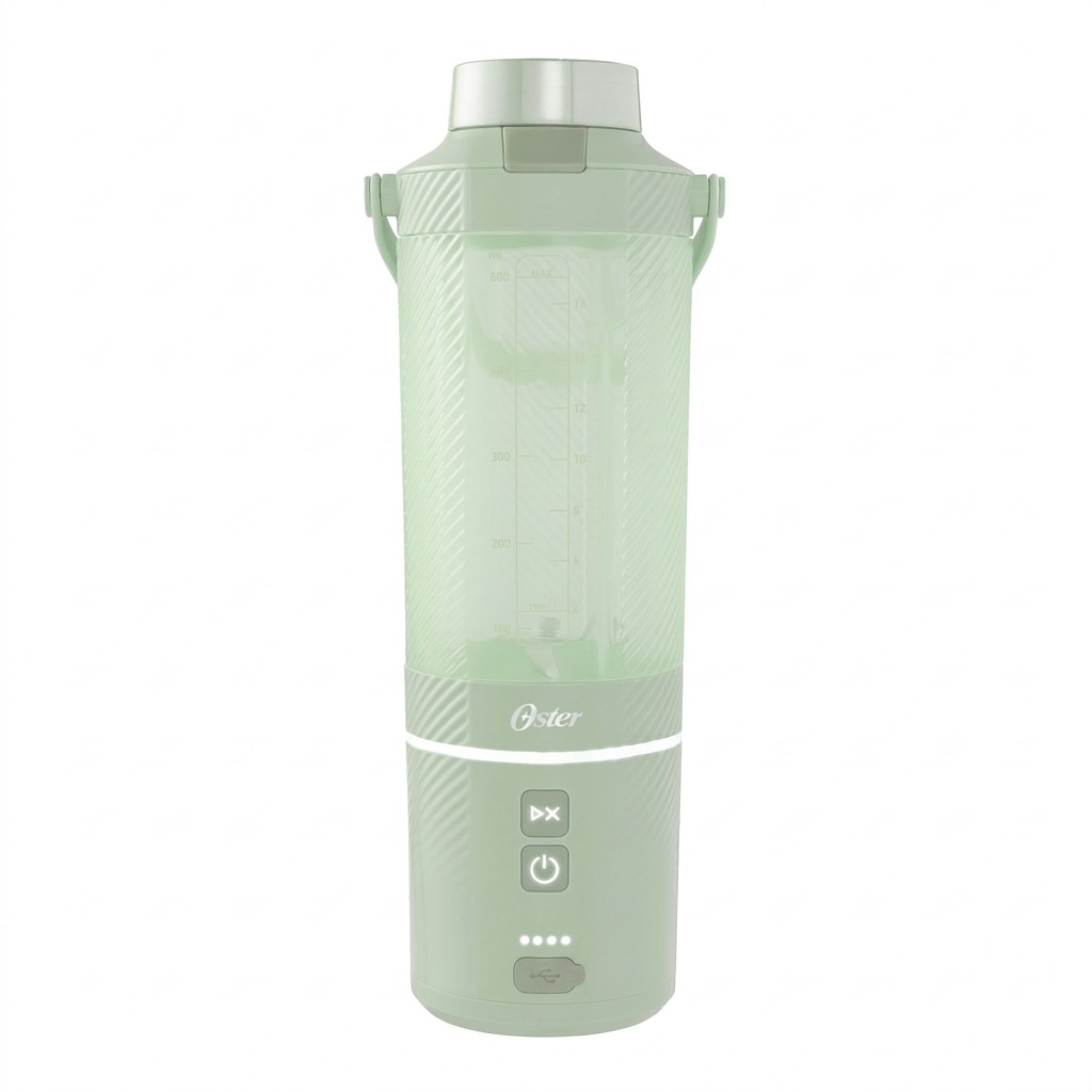 A hand sits beside the Matcha Green Oster GoMAX Portable Blender on a desk for scale reference.